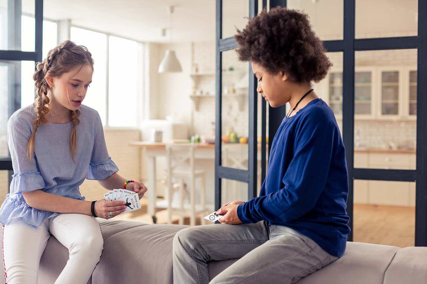 Two kids playing Remoji